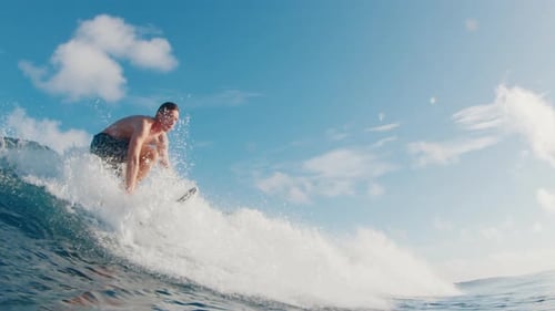Young Man Surfs the Wave in the Maldives