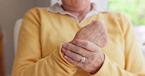 Senior woman, wrist or hands with pain, injury closeup or orthopedic issue at home alone