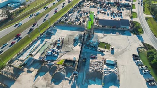 Concrete Mixing Factory at Industrial Area with Cement Trucks and Heavy Building Equipment