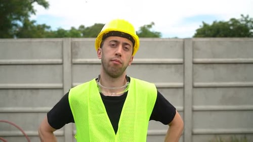 Front Portrait Of Laborer Looking At Camera, Wearing Hard Hat And Reflective Safety Vest. medium sho