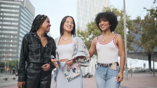 Transgender Woman and Two Friends Walking Embracing Together in the Street
