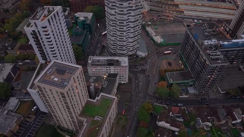 Aerial view circling above Croydon high rise apartment towers in low evening sunlight