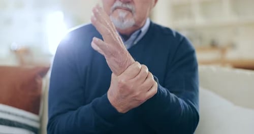 Hands, senior man and wrist with pain, injury and orthopedic wound at home
