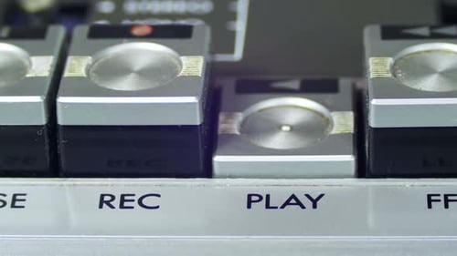 Pushing Play Button on a Vintage Tape Recorder