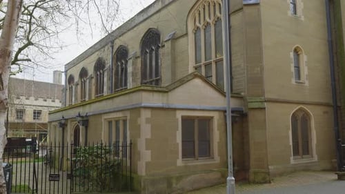 Classic Victorian brick architecture building with birch trees in front
