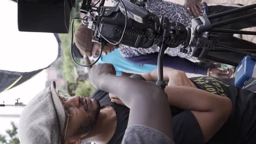 The Film Crew is Arranging the Camera Equipment for a Commercial Video Shoot - Vertical Shot