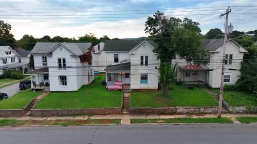 Rural low income poor housing in Appalachia. Rising aerial reveals mountains in distance. American U