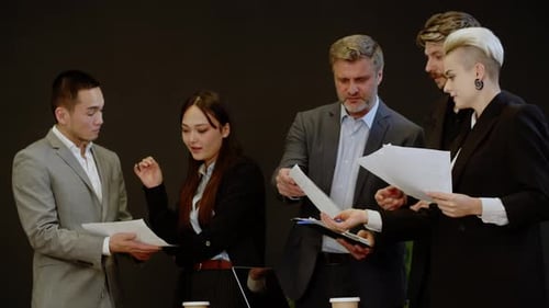 Successful Five Business People Analyzing Stocks Indoors Strategy Discussion About Economics