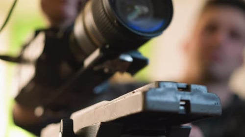 Closeup of Camera Tripod Quick Release Plate with Blurry Camera