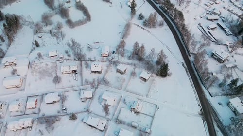A Snow-Covered Residential Roofs During Winter Of Sunrise. Aerial Shot