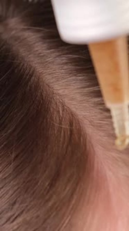 Applying Scalp Scrub Closeup Hair Care