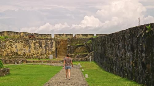 Rear View of woman walking along the Galle Dutch Fort wall observing the remains, Sri Lanka