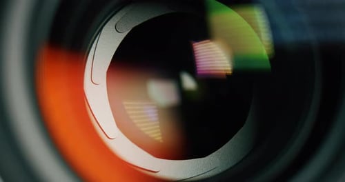 Extra macro of anonymous modern photo or video camera with a wide aperture diaphragm lens while op