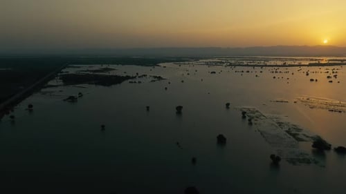 River Sutlej flood submerging Bahawalpur landscape at sunset