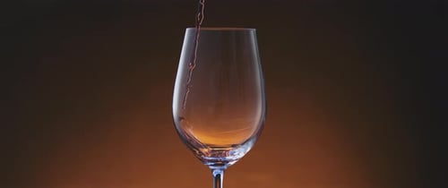 Pouring red wine into a glass