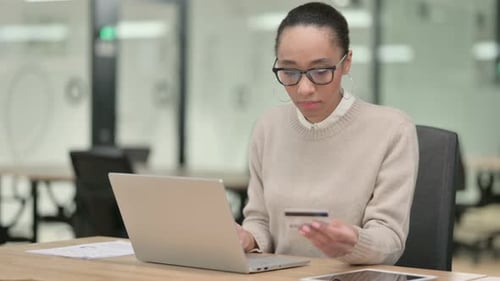 Creative African Woman Having Online Payment Success on Laptop