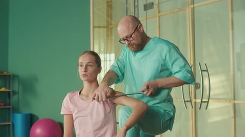 The Personal Trainer Gives the Athlete a Massage to Restore Physical Functions