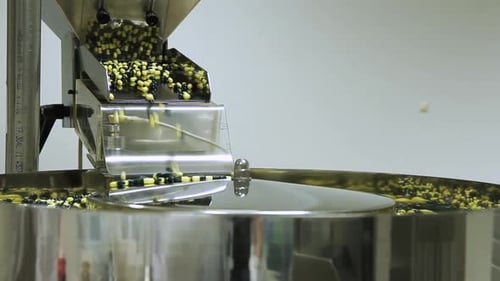 Tablets Falling From Feeder Into Distributor