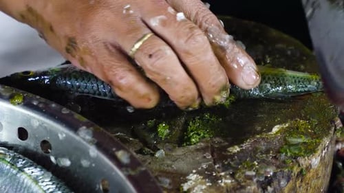 Woman is Cutting Fish at a Seafood Market