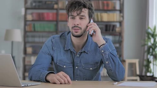 Phone Talk Young Man Attending Call at Work