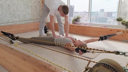 Helping Woman At Stretching Simulator