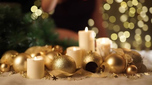 Girl Puts a Christmas Toy On a Christmas Background