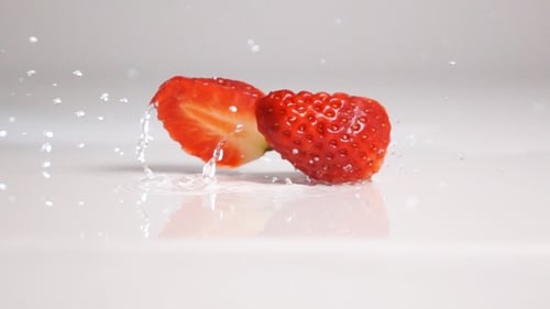Sliced Strawberry Fall On White Surface