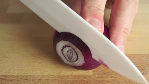 Amateur Cooking Of Greek Salad. Part Of The Set. Man Cutting Red Onion