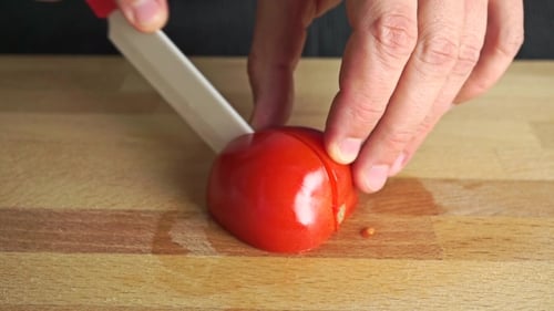 Amateur Cooking Of Greek Salad. Part Of The Set. Man Cutting Red Tomato