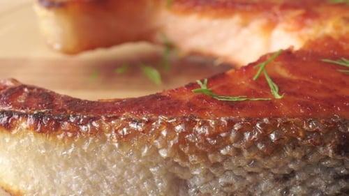 Crispy Salmon Steak On Light Wooden Cutting Board