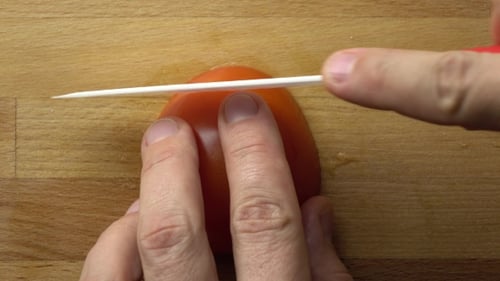 Cooking Vegetable Salad: Cutting Red Tomato On Cutting Board