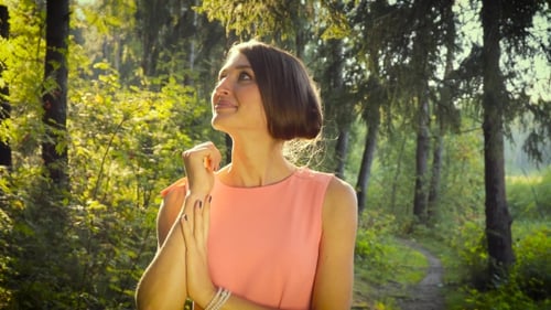 Walking Girl In a Pink Dress In The Woods On a Sunny Day.