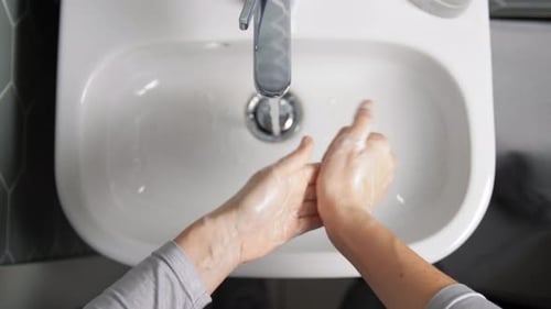 Close Up of Woman Washing Hands with Soap Foam