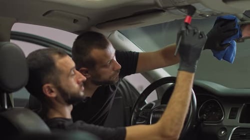 Close Up Shooting of Car Wash Workers Two Workers in the Car Interior Cleaning