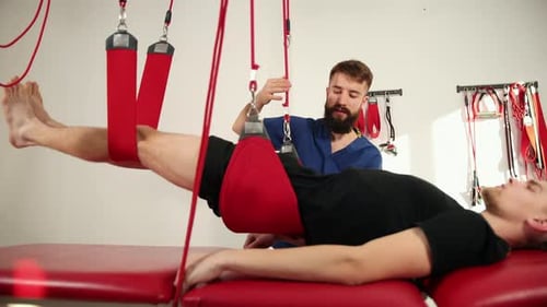 Orthopedic Doctor Makes a Diagnosis of the Muscle Tone on Legs