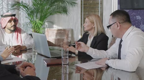 Multi-Ethnic Team Of Investors Discussing Business Strategy