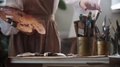 Young Woman Artist Choosing a Brush