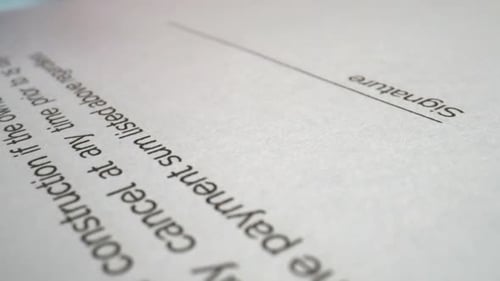 Businessman sign signature on document contract paper at office desk