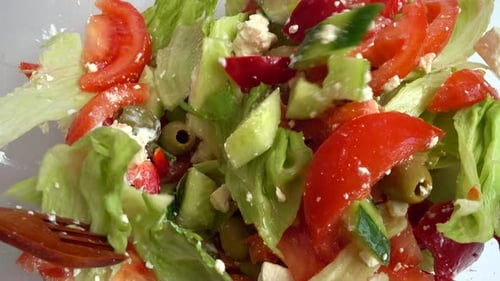 Preparing a salad in a glass bowl