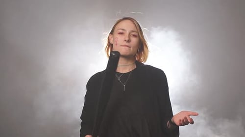 Confident Feminist Girl with Bat in Smoky Space