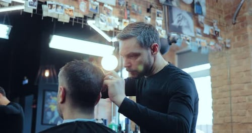 Professional Hairdresser Cuts the Client in the Barber Shop