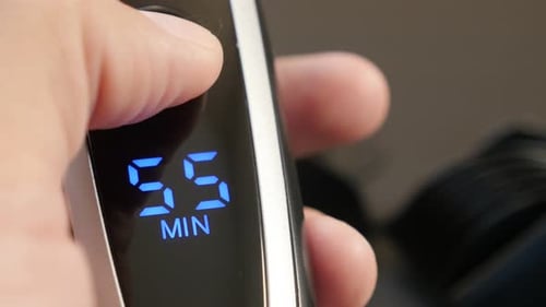 Powering modern multi-cut clipper with LED display close-up 4K 2160p 30fps UHD footage - Cordless b