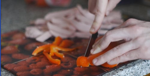 A Cook Cuts Pepper