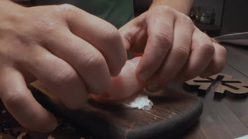 Chef Makes Rolls with Bacon and Chicken Chest on the Dark Wooden Board in the Kitchen, Close Up Shot