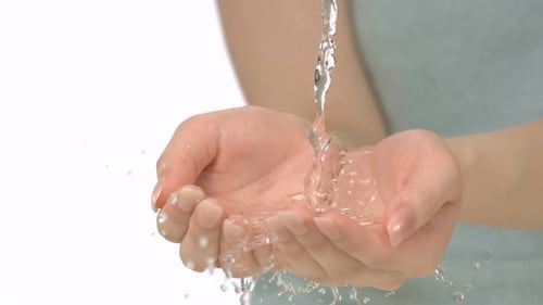 Water pouring in woman's hands, Slow Motion
