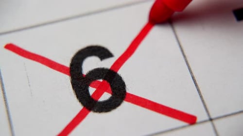 The 6St Number in the Calendar is Crossed Out with a Red Cross in a Macro on a White Sheet