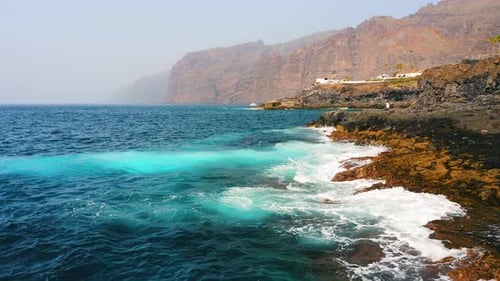 Evening Atlantic Ocean Foamy Waves Rolling at Rocky Shore