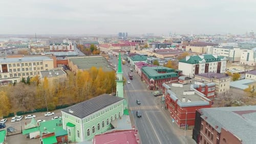 Long Avenue with Driving Cars and Vintage Buildings on Sides