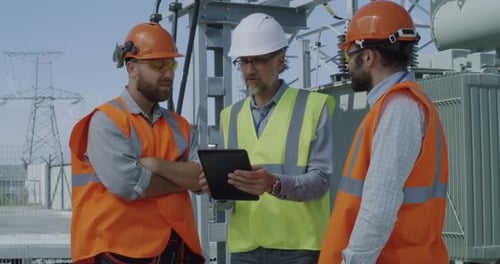 Foreman Speaking with Colleagues on Power Station