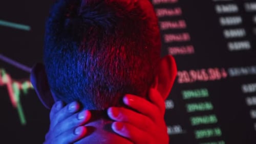 Trader Analyze Cryptocurrency Charts on a Big Screen in the Dark